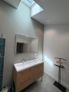 a bathroom with a sink and a mirror on the wall at Maison des Capucins in Nérac
