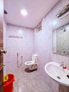 a bathroom with a toilet and a sink at CK Beach House in Chennai