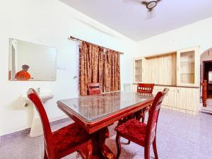 a dining room with a table and two chairs at CK Beach House in Chennai