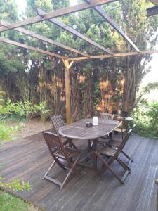 a wooden table and chairs on a wooden deck at Entire maisonette in Tarn in Busque