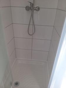 a shower with a shower head in a bathroom at Entire maisonette in Tarn in Busque
