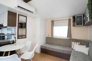 a living room with a couch and a table at Diófa Vendégház in Pilismarót