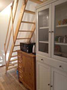 a kitchen with a microwave on a wooden cabinet at Entire maisonette in Tarn in Busque +5 photos