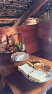 a table with a plate of bread and sandwiches on it at Wonderful Hostel Trincomalee in Trincomalee