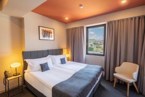 a hotel room with a bed and a window at King Tamar Hotel By Luxuria Hotels in Tbilisi City +40 photos