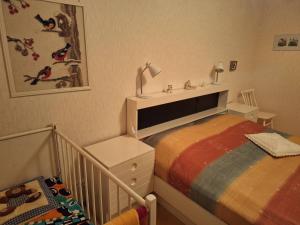 a baby room with a bed and a crib at Suns Tupa - Travellers Marmalade in Siikalatva