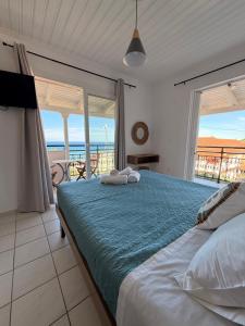 a bedroom with a bed with a view of the ocean at Vaso Alykanas Studios in Alikanas