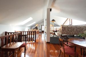 a living room with a couch and a table and chairs at IZURRENEA Casa Rural in Arano