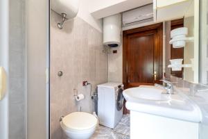 a bathroom with a toilet and a sink at Harmony in Nulvi +23 photos