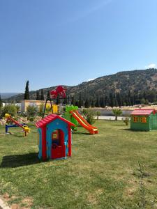 a playground with a slide and a play house at Pamukkale Kaya Termal Otel in Pamukkale