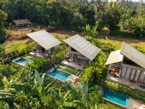 an aerial view of a house with two swimming pools at Sayuban Villa in Susut