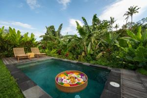 a swimming pool with a basket of food in it at Sayuban Villa in Susut