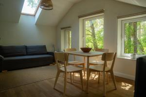 a living room with a table and chairs and a couch at Nidos SKALVA in Neringa