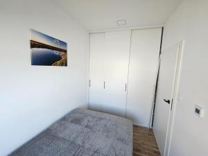 a bedroom with white walls and white closets at Olmar Przybrodzin in Przybrodzin