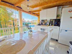 a kitchen with a counter and a large window at Villa Lea in Bihać