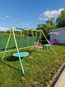 a park with a swing set in the grass at Villa Lea in Bihać