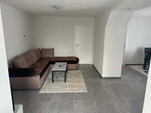 a living room with a couch and a table at Apart centar Pliva , Jajce in Jajce