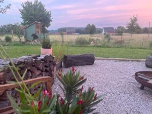 a garden with a stone wall and a table and flowers at Ferienwohnung Vielfalt in Höringhausen +20 photos