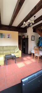 a living room with a couch and a table at La Casuca de Pechón in Pechón