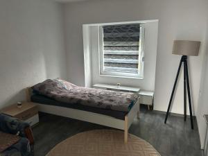 a small bedroom with a bed and a window at Apart centar Pliva , Jajce in Jajce