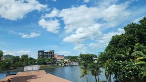 a view of a river with buildings and trees at Utime Riverside Kanchanaburi in Ban Yang (2)