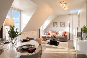 a living room with a couch and a table at Sebastopol Chic Balcon & Parisian View in Paris
