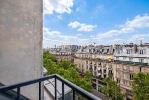 a view of a city from a balcony at Sebastopol Chic Balcon & Parisian View in Paris