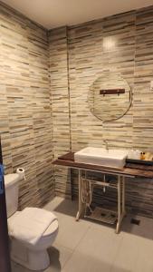 a bathroom with a white toilet and a sink at Utime Riverside Kanchanaburi in Ban Yang (2) +15 photos
