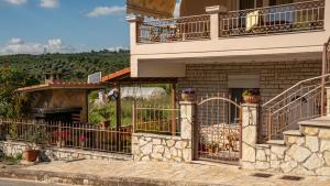 a house with a balcony and a patio at Nice & Cosy apartment in Igoumenitsa in Igoumenitsa