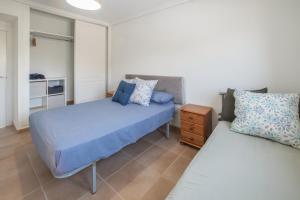 a bedroom with two beds with blue sheets and a night stand at Sun & Golf Stay in Baños y Mendigo +15 photos