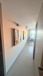 a hallway with white walls and a tile floor at La Perla Del Mar APARTAMENT in Torrevieja