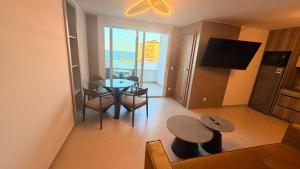 a living room with a table and chairs and a view of the ocean at La Perla Del Mar APARTAMENT in Torrevieja
