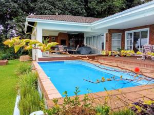 a swimming pool in the backyard of a house at Lagoon Lodge in Freeland Park