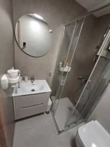 a bathroom with a shower and a sink and a mirror at Costa Royale APARTAMENT in Torrevieja
