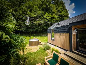 a backyard with a hot tub and a house at Posestvo Brida in Ilirska Bistrica