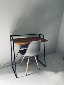 a desk with a chair next to a wall at Koshoka Home in Ompanda