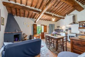 a kitchen with a living room with a fireplace at Tenuta Bichi Borghesi in Monteriggioni
