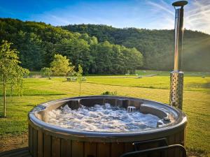 a hot tub in the middle of a field at Posestvo Brida in Ilirska Bistrica