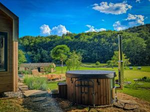a wooden barrel with a grill in a yard at Posestvo Brida in Ilirska Bistrica