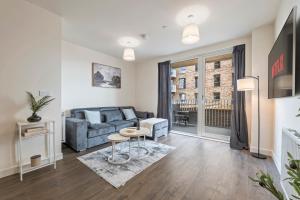 a living room with a couch and a table at Stylish 1-Bed flat with Private Balcony in Hatch End