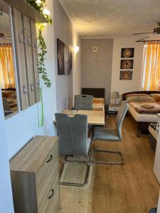 a room with a table and chairs and a bedroom at Studio Florida in Štúrovo