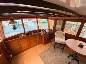 a small room with a table and a chair in a boat at The Oak & Anchor - Hong Kong Houseboat in Hong Kong