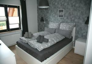 a bedroom with a bed with pillows on it at Ferienwohnung Möbus in Fritzlar +19 photos