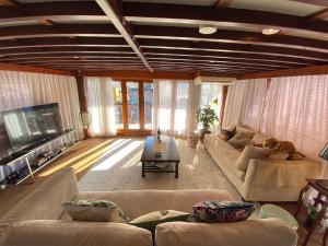a large living room with couches and a tv at The Oak & Anchor - Hong Kong Houseboat in Hong Kong