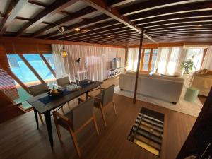 a living room with a table and chairs and a couch at The Oak & Anchor - Hong Kong Houseboat in Hong Kong