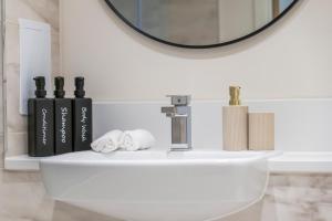a bathroom with a white sink and a mirror at Stylish 1-Bed flat with Private Balcony in Hatch End +18 photos