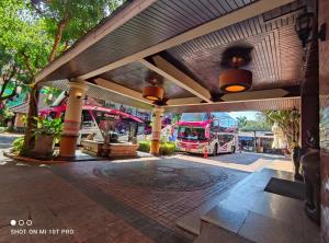 a bus parked under a pavilion with a bus at Chiangmai Gate Hotel in Chiang Mai