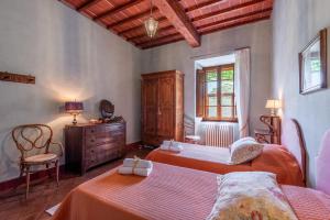 a bedroom with two beds and a dresser and a window at Tenuta Bichi Borghesi in Monteriggioni +68 photos