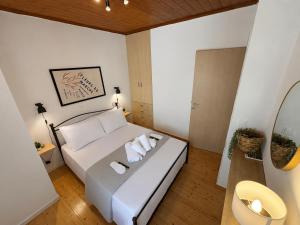 a bedroom with a white bed with towels on it at Salt & Stone in Drymon