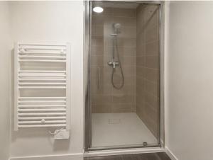 a shower with a glass door in a bathroom at Sweetly La Rochelle in La Rochelle